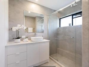 a bathroom with a sink and a shower at NEW - Sunny Coolum Beach Retreat in Coolum Beach