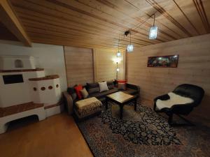 a living room with a couch and a chair at Allgäu Bergblick in Leutkirch im Allgäu