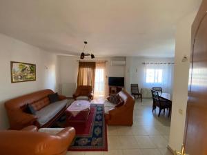 a living room with couches and a dining room at Lovely flat in the heart of Korca #7 in Korçë