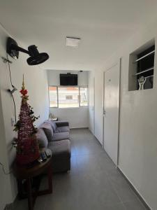a living room with a couch and a christmas tree at Casa de Mainha - Vila Mariana - unidade 2 in Sao Paulo