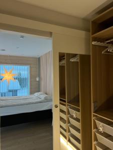 a bedroom with a bed and a closet with a window at Villa Golden House in Rovaniemi