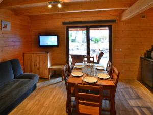 a dining room with a table and a couch at Holiday houses close to the beach, Siano ty in Sianozety