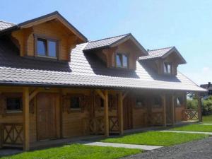 a wooden house with a gambrel roof at Holiday houses close to the beach, Siano ty in Sianozety