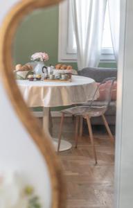 a table with a plate of food on it at Studio liberty a 100 metri dalle mura in Bassano del Grappa +7 photos