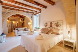 a bedroom with a large white bed in a room at GH Flat Studio S.Martino in Carloforte