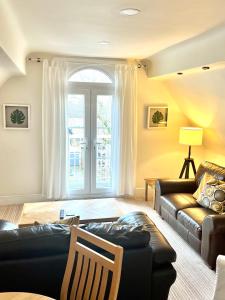 a living room with a couch and a chair at Holland House in New Brighton