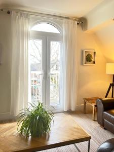 a living room with a large window and a couch at Holland House in New Brighton