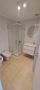 a bathroom with a shower and a toilet and a sink at Departamento frente al mar en Monte Hermoso in Monte Hermoso