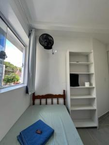 a small bedroom with a bed and a window at Casa de Mainha - Vila Mariana - unidade 1 in Sao Paulo