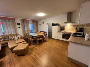 a kitchen and a living room with a table at Ferienhaus Frei 2 Titisee in Titisee-Neustadt