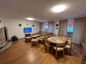 a living room with a table and a couch at Ferienhaus Frei 2 Titisee in Titisee-Neustadt