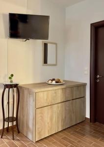 a wooden dresser with a plate of food on top of it at Stone House - Bike Friendly Home in Edessa
