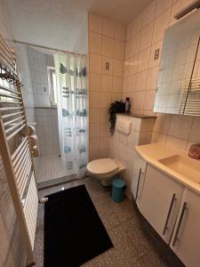 a white bathroom with a toilet and a sink at OhPardon! GAILDORF - Monteurwohnung im EG, Einzelbetten, Loggia & Garten in Gaildorf
