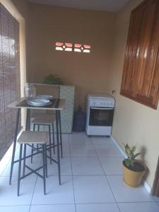a small kitchen with a table and a stove at Chez Nana in Cayenne