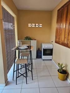 a kitchen with a table and chairs and a stove at Chez Nana in Cayenne