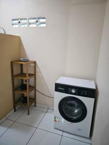 a washing machine in a corner of a room at Chez Nana in Cayenne