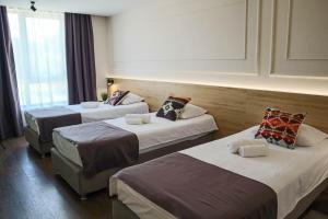 Postel nebo postele na pokoji v ubytování Hotel Dijana