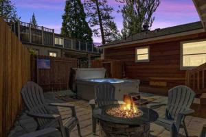 a backyard with a fire pit and chairs and a hot tub at Base Camp New Ski Slope Views with HOT TUB. in Big Bear Lake