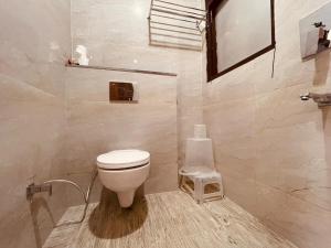 uma casa de banho com um WC branco num quarto em Wooib Hotels, Haridwar em Haridwar