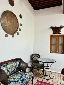 a living room with a table and two chairs at DAR Naima in Fez