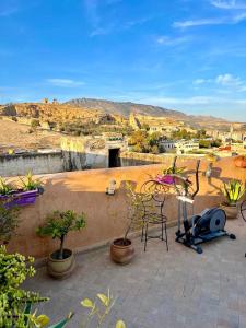 a patio with chairs and plants and a view of the desert at DAR Naima in Fez
