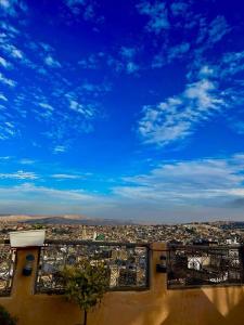 a view of a city with a blue sky at DAR Naima in Fez