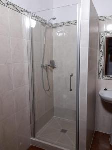 a bathroom with a shower and a sink at Casa do Celeiro - Monsaraz in Monsaraz +18 photos