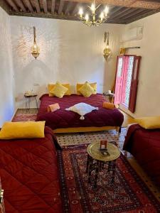 a bedroom with a large bed and a couch at DAR Naima in Fez