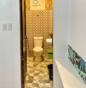 a bathroom with a toilet and a sink at Precious Homestay -Suite Room in Burgos