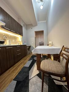a kitchen with a table and chairs in a room at 1-room apart. 21 on Usenbaeva 52 near Eurasia shopping center in Bishkek