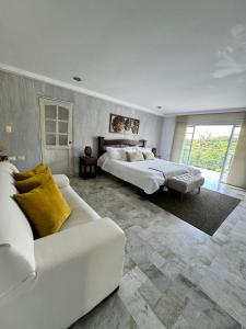 a large bedroom with two beds and a couch at Casa Merchu Finca Spa in Puerto Espejo