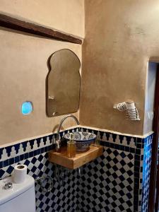a bathroom with a sink and a mirror at DAR Naima in Fez