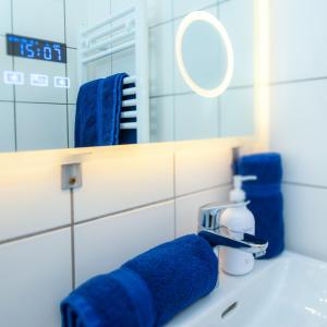 a bathroom with blue towels on a sink at Home Suites Home in Vienna