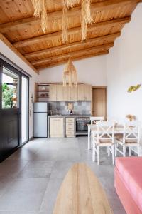 a kitchen with a wooden ceiling and a table at Monopati Eco Stay in Raches