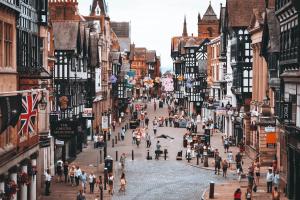 a group of people walking down a city street at Luxury Apartment: city centre, stylish, modern in Chester