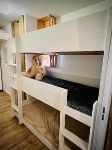 a teddy bear sitting in a bunk bed at Appart 5pers joue du loup pied de pistes vue top in La Joue du Loup
