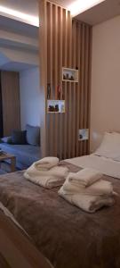 a bedroom with two beds and a couch at President Kop Apartman 106 in Kopaonik +69 photos