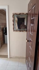 a door in a room with a mirror on the wall at Gardenia City cairo airport in Cairo