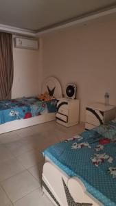 a bedroom with two beds and a table and chairs at Gardenia City cairo airport in Cairo