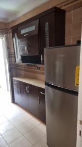 a kitchen with a stainless steel refrigerator at Gardenia City cairo airport in Cairo