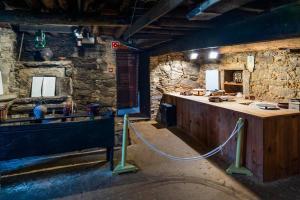 a stone room with a counter and a counter at Apartamento Catuxa in Malpica