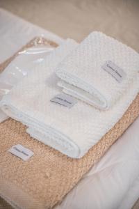 two white towels sitting on top of a table at La Casa di Valeria - Modena in Modena