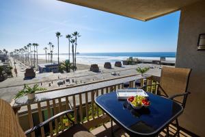 a table with a bowl of fruit on a balcony overlooking the beach at Oceanfront condo at North Coast Village in Oceanside