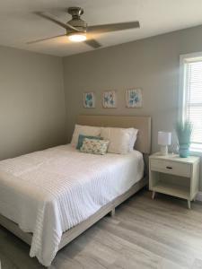 a bedroom with a bed and a ceiling fan at Tropical Haven in Panama City Beach
