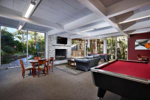 a living room with a pool table and a fireplace at Oceanfront condo at North Coast Village in Oceanside