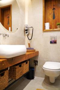 Un baño con lavabo, inodoro y espejo. en Bansko Nest, en Bansko