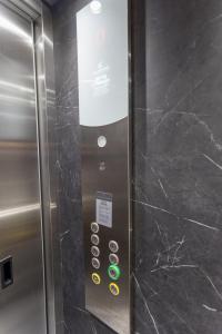 an elevator in a subway train with a sign on it at Varkiza Luxury Suites by Raise in Vari