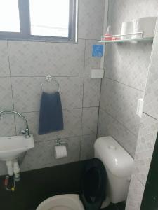 a small bathroom with a toilet and a sink at Barrett Accommodation Rooms in Suva