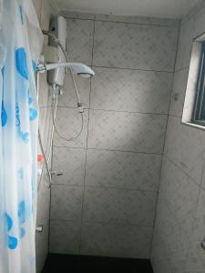 y baño con ducha y cortina de ducha. en Barrett Accommodation Rooms, en Suva