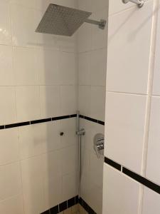 a bathroom with a shower with white tiled walls at Ferienwohnung Auszeit in Boppard